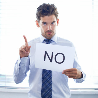man holding note that says NO