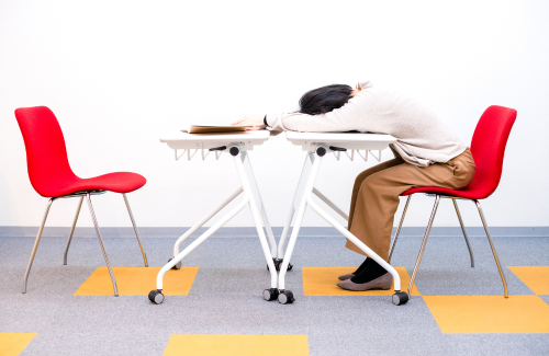 man slouched over desk